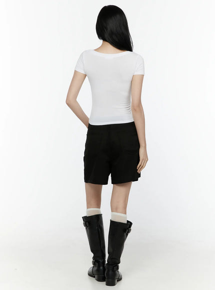 Basic V-Neck Crop Top IL506 White back view on model showing clean back neckline and cropped hem styled with black shorts and boots