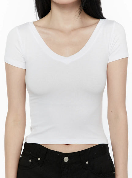 Basic V-Neck Crop Top IL506 White close-up front on model showing V-neckline ribbed stretch fabric cropped hem with black jeans