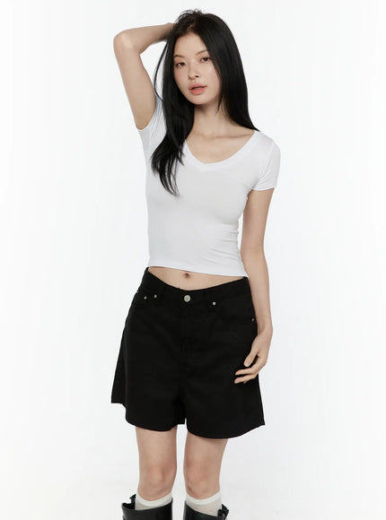Basic V-Neck Crop Top IL506 White front view on model arm raised showing fitted silhouette and cropped length paired with black shorts