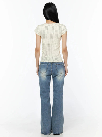 Bay Low Rise Bootcut Jeans IL509 Blue back full-length shot on model wearing cream polka dot top showing back pockets and wide bootcut hem