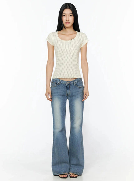 Bay Low Rise Bootcut Jeans IL509 Blue full-length front shot on model standing straight arms at sides wearing cream polka dot top and strappy sandals