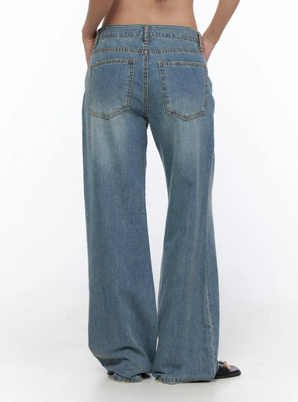 Beau Low-Rise Wide Jeans CL510 Blue back view on model showing dual patch pockets, gold topstitching, and wide-leg washed denim silhouette