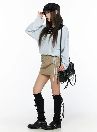 LEWKIN Belted Mini Skirt CL514 Beige size S full-body side shot on model styled with light blue top, black leg warmers, and black loafers
