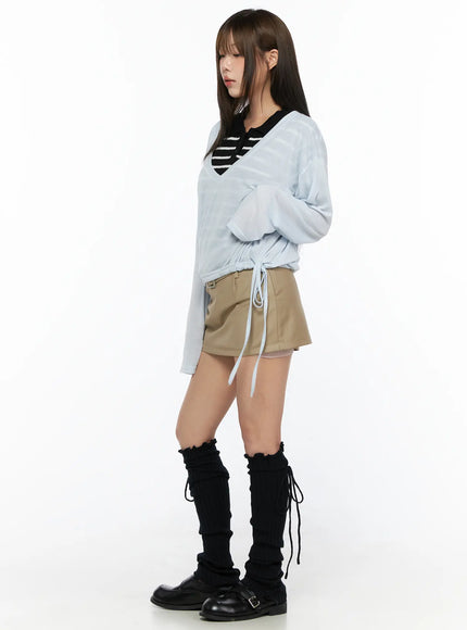 Belted Mini Skirt CL514 Beige full-body side shot on model in light blue sheer drawstring top showing skirt silhouette with black leg warmers