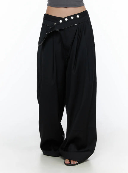 Belted Pintuck Wide Slacks CL510 black front close-up of low-rise V-waistband with silver snap buttons pintuck pleats and voluminous wide leg