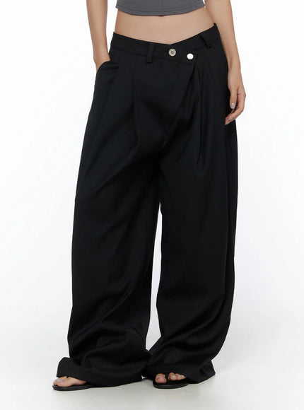 Belted Pintuck Wide Slacks CL510 black front mid-shot on model showing asymmetric V-waist silhouette pintuck pleats and wide pooling hem