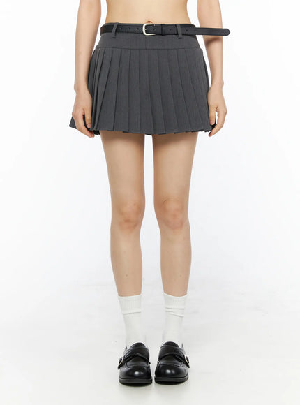 Belted Pleated Skirt CU530 Dark gray front shot on model showing full pleated silhouette black leather belt silver buckle white socks black loafers