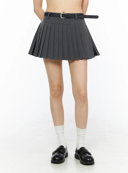LEWKIN Belted Pleated Skirt CU530 Dark gray front crop shot on model size S with black leather belt white socks black loafers hands behind back