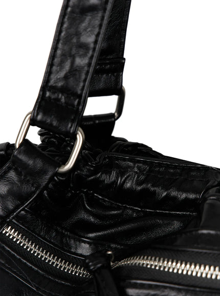 Black Zipper Shoulder Bag IL523 Black close-up top corner detail shot showing silver D-ring strap attachment ruched leather gathering and zip pocket edge
