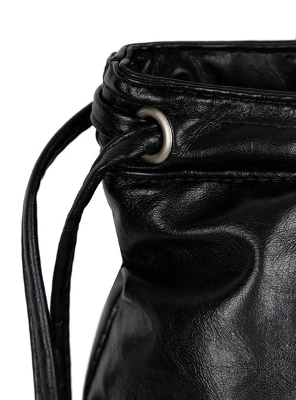 Black Zipper Shoulder Bag IL523 Black close-up side detail shot showing silver eyelet grommet drawstring cord ruching and crinkled leather texture near strap