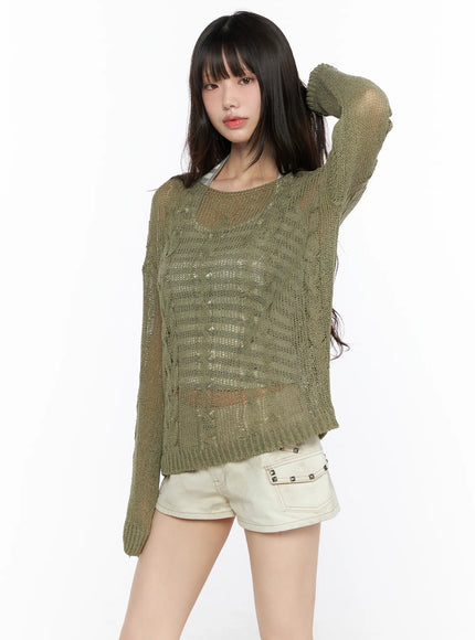 Boat Neck Sheer Cable Knit Top CL522 Dark green front model shot hand raised to head highlighting sheer knit body and ribbed hem