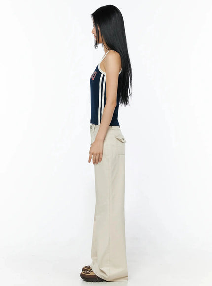 Bootcut Cargo Pants IL516 Light beige side view full-length on model, profile stance showing flared bootcut silhouette and cargo pocket depth, styled with navy cami