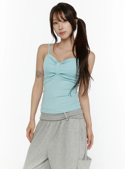 Bow Detail Sleeveless Top CL508 Mint three-quarter front shot on model with ponytail showing bow chest detail ribbed texture thin straps and grey drawstring pants