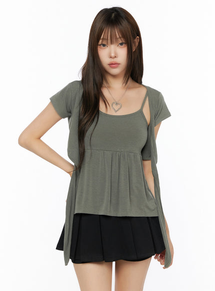 Bow-Detail Tank Set IL523 Khaki Green front shot on model, open-front wrap silhouette, square-neck inner tank, gathered peplum hem, paired with black pleated skirt