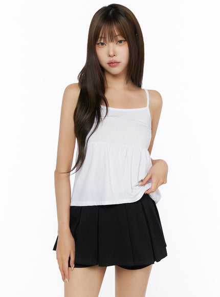 Bow-Detail Tank Set IL523 White S/M front shot on model showing inner cami tank only, spaghetti straps, square neckline, gathered peplum silhouette, black pleated mini skirt