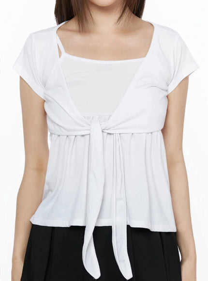 Bow-Detail Tank Set IL523 White S/M close-up front detail shot on model, square neckline, layered wrap panel, center front-tie bow knot with gathered peplum, jersey texture