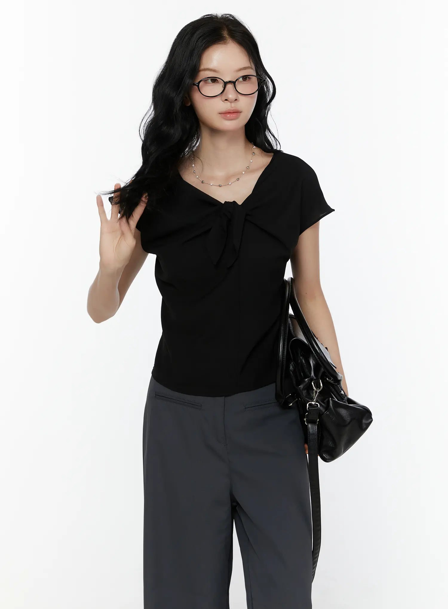 LEWKIN Bow Tie Cap Sleeve Blouse CL520 Black S/M front shot on model wearing glasses paired with grey wide-leg trousers and black leather bag