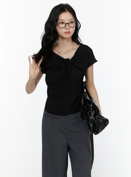 LEWKIN Bow Tie Cap Sleeve Blouse CL520 Black S/M front shot on model wearing glasses paired with grey wide-leg trousers and black leather bag