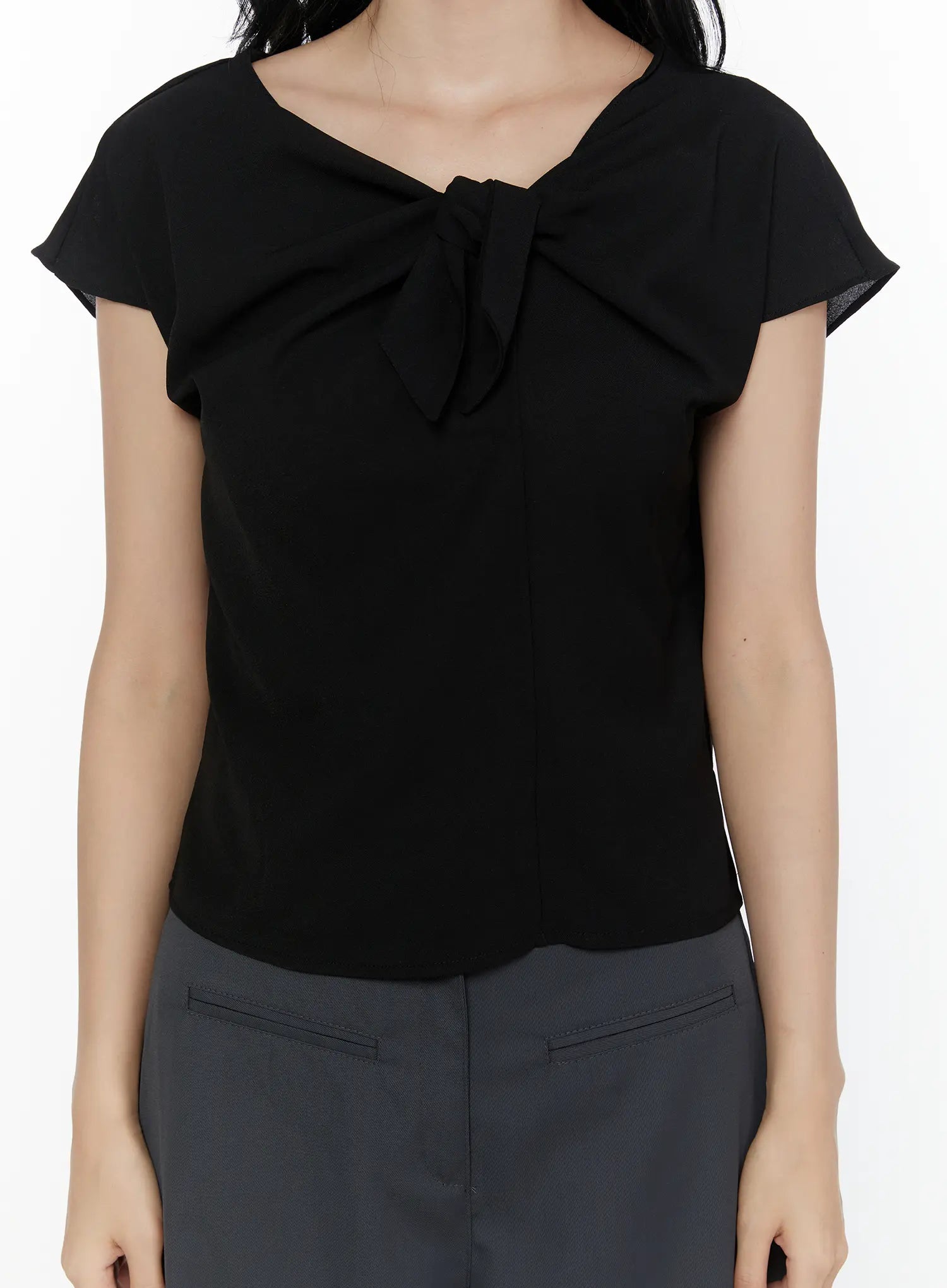 Bow Tie Cap Sleeve Blouse CL520 Black close-up front shot on model showing bow tie chest detail asymmetric neckline and cap sleeve edge