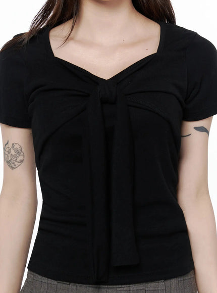 Bow Top IL506 Black close-up chest detail shot on model showing sweetheart neckline with structured bow-knot and gathered fabric texture
