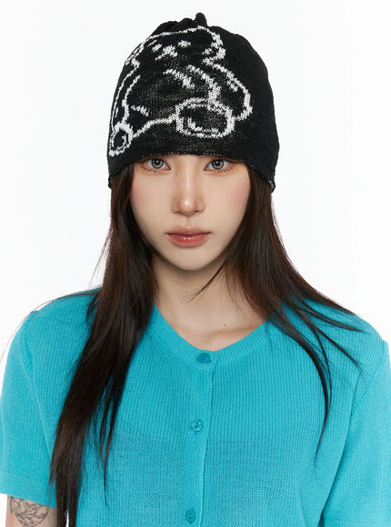 LEWKIN Brooks Bear Beanie IL503 Black front view on model wearing teal knit cardigan, white bear graphic intarsia knit beanie pulled low over forehead