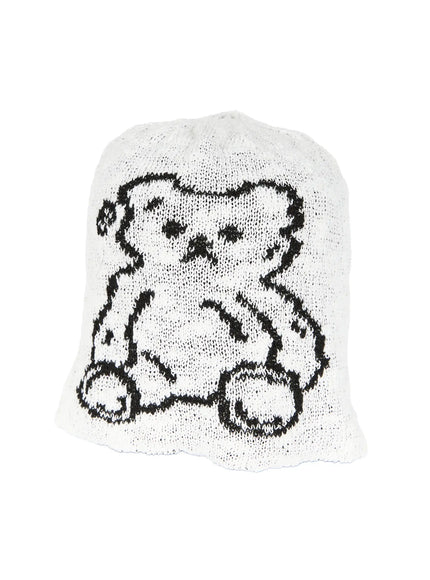 Brooks Bear Beanie IL503 White angled flat product shot, black teddy bear intarsia graphic on loose open-knit white beanie, slight three-quarter view