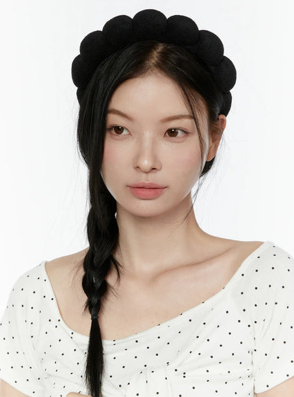 Bubble Headband IL506 Black close-up front model wearing black terry bubble headband with long braided hair and polka dot top