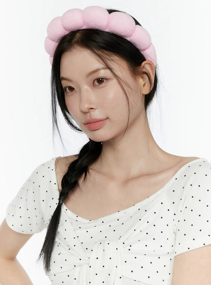 Bubble Headband IL506 Light Pink close-up front model wearing light pink puffy bubble headband with loose braided hair
