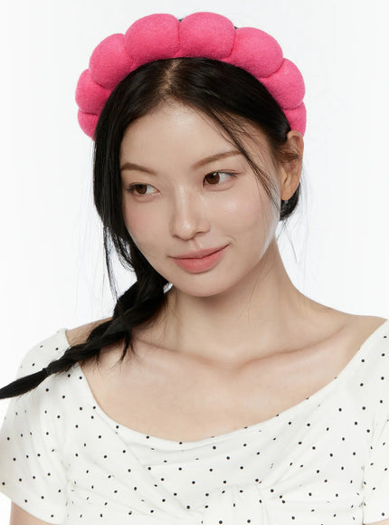 Bubble Headband IL506 Hot Pink close-up front model wearing hot pink terry bubble headband gazing sideways with braided hair