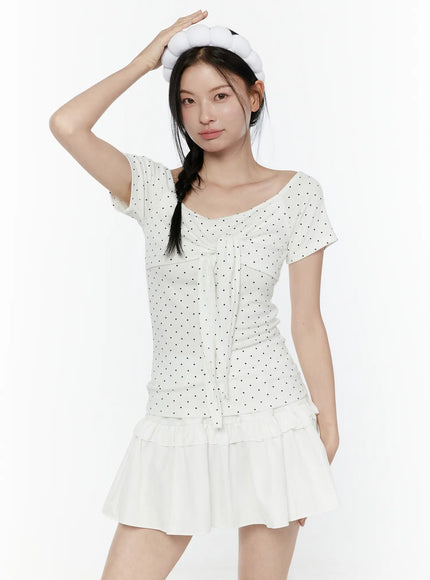 Bubble Headband IL506 White full-body front model wearing white bubble headband hand raised to head paired with polka dot top and ruffled skirt