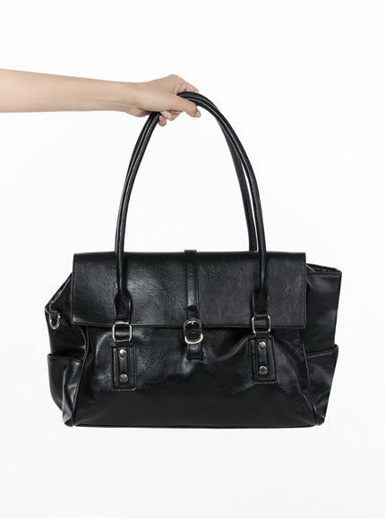 LEWKIN Buckle Faux Leather Shoulder Bag IL523 Black front view held by hand showing flap closure silver buckles and crinkled faux leather texture