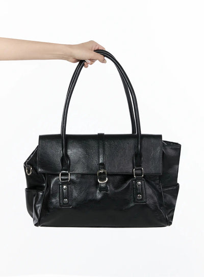 LEWKIN Buckle Faux Leather Shoulder Bag IL523 Black front view held by hand showing flap closure silver buckles and crinkled faux leather texture