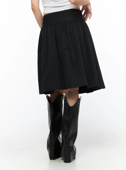 Buckle Midi Skirt CL517 Black back model shot revealing smooth gathered skirt panel, back zip closure, and side buckle hardware at waistband