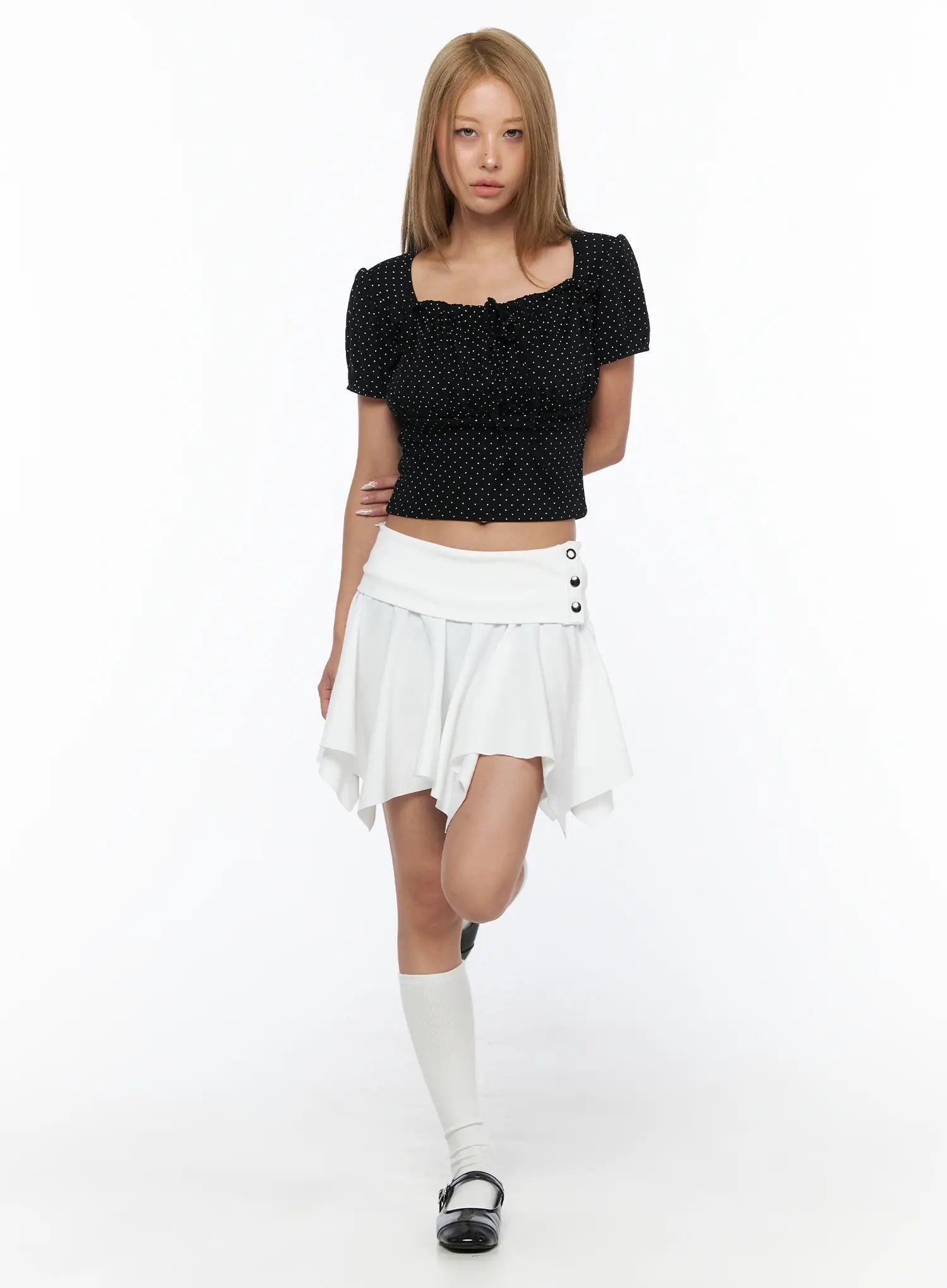 Button Flare Mini Skirt CU524 White full-body front shot on second model styled with black polka dot crop top, white knee socks, walking pose