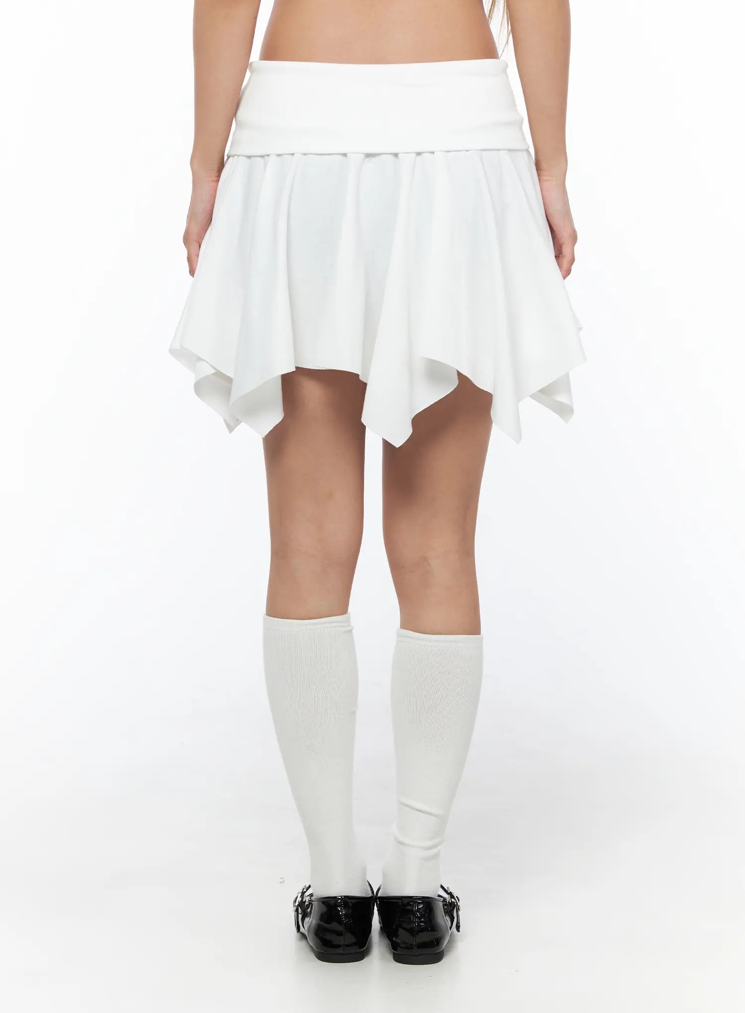 Button Flare Mini Skirt CU524 White back shot on model showing clean folded waistband, flared handkerchief hem, and pleated skirt construction