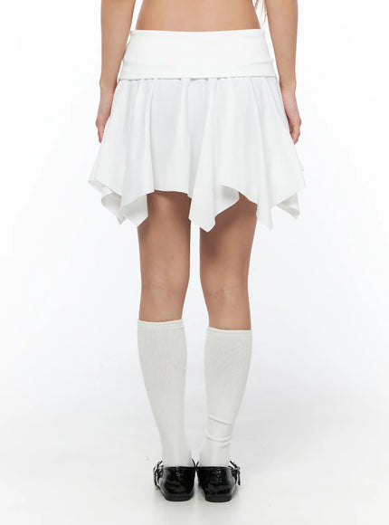 Button Flare Mini Skirt CU524 White back shot on model showing clean folded waistband, flared handkerchief hem, and pleated skirt construction