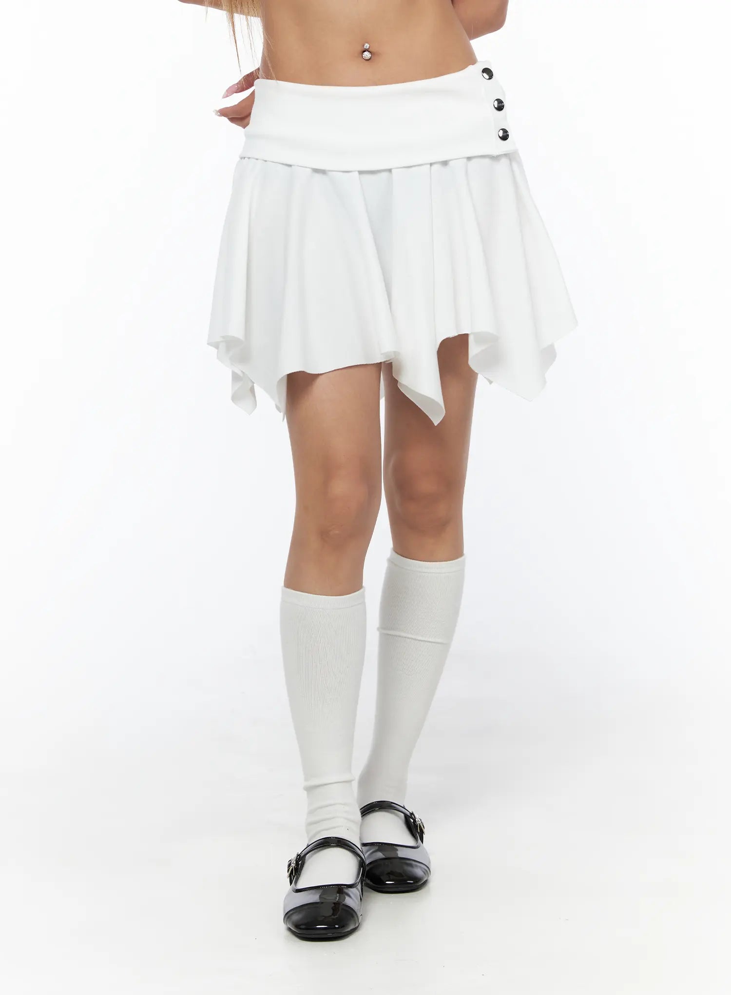 Button Flare Mini Skirt CU524 White close-up front shot on model showing folded waistband, silver button detail, and asymmetric handkerchief hem