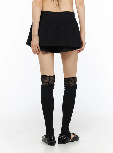 Button Flare Mini Skirt CU530 Black back close-up shot on model showing smooth wide waistband, flared back hem, and built-in shorts lining