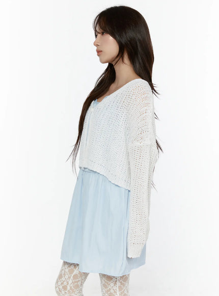 Button Knit Cardigan CL508 White side shot on model showing relaxed open-knit cropped body, long sleeves, and layered styling over light blue mini dress with lace tights