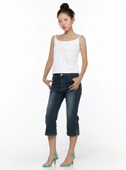 Button Sleeveless Top CL510 White full-length front shot on model standing upright hands in pockets styled with cropped flare jeans and teal heels
