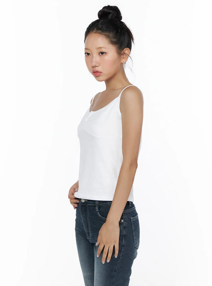 Button Sleeveless Top CL510 White side view on model showing slim spaghetti strap silhouette and fitted knit fabric paired with dark jeans