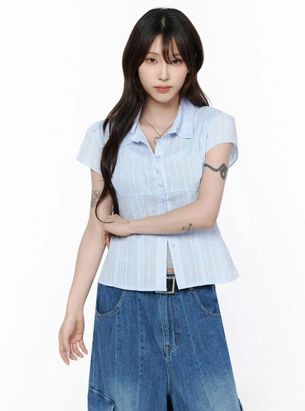 Button Up Linen Summer Blouse IL506 Light blue front upper-body shot on model touching hair showcasing cap sleeve and button-down detail