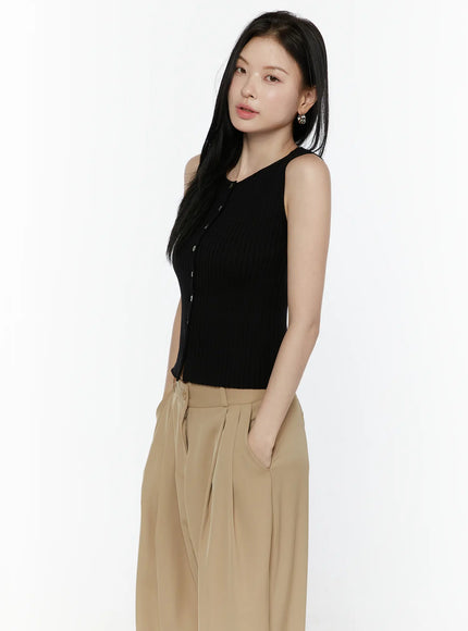 Button-Up Tank Top IL506 Black three-quarter side shot on model with hand in pocket, ribbed knit sleeveless top with button placket