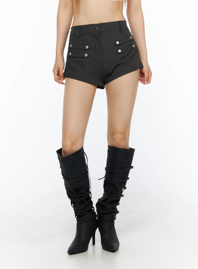 Buttoned Military High Waist Shorts CL502 Dark gray front close-up on model showing silver snap button pocket details, waistband, and asymmetric hem