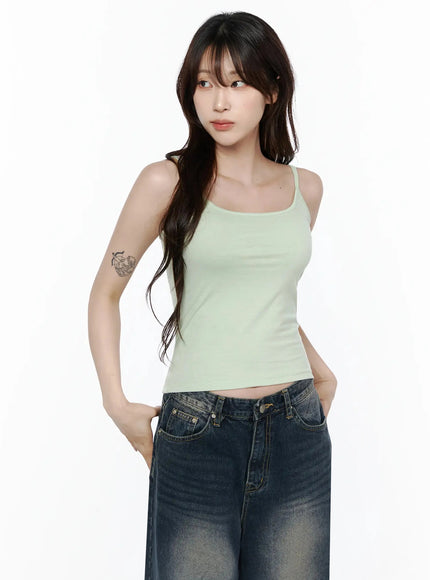 Cami Tank Top IL506 Mint front shot on model looking sideways, hands in pockets, slim cropped fit with thin straps, styled with dark wash wide-leg denim