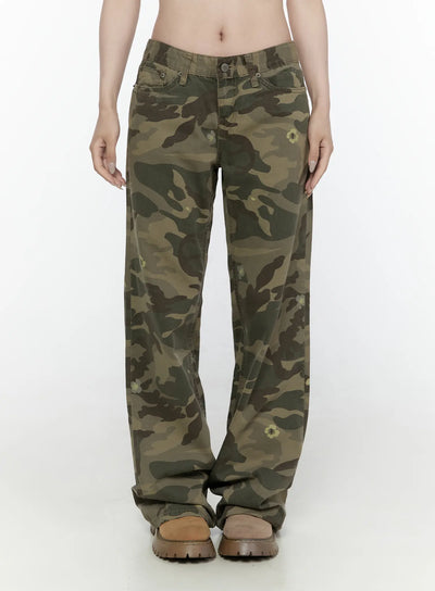 LEWKIN Camo Cargo Trousers IL522 Dark green front view on model wearing cropped white graphic tee and belt, wide-leg low-rise camo pants with floral print