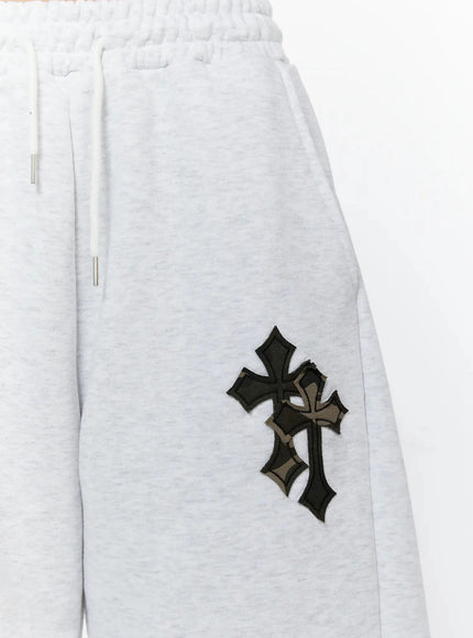 Camo Cross Patch Bermuda Shorts IU524 Light gray close-up detail of layered black and camo cross appliqué patch on left leg with elasticated drawstring waistband