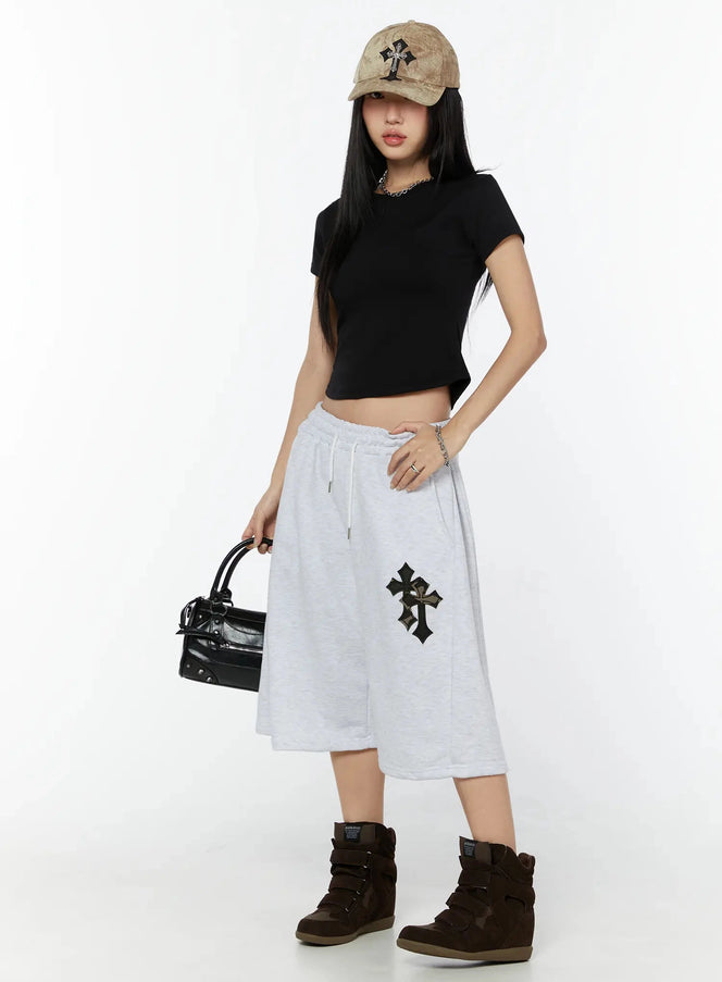 Camo Cross Patch Bermuda Shorts IU524 Light gray full-body front shot on model styled with black crop tee, tan cap, black bag and brown wedge sneakers