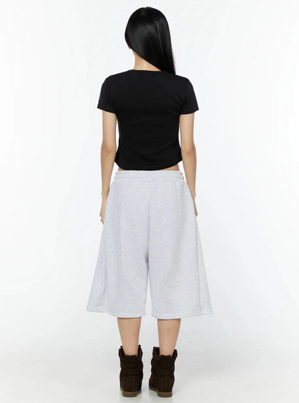 Camo Cross Patch Bermuda Shorts IU524 Light gray full-body back view on model showing clean plain rear panel, elasticated waistband and wide-leg cut with brown sneakers