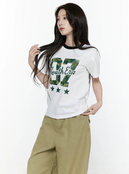Camo Graphic T-Shirt IL522 White upper-body angled front shot on model touching hair black ringer crewneck camo 07 Youth Era graphic print star motif short sleeve